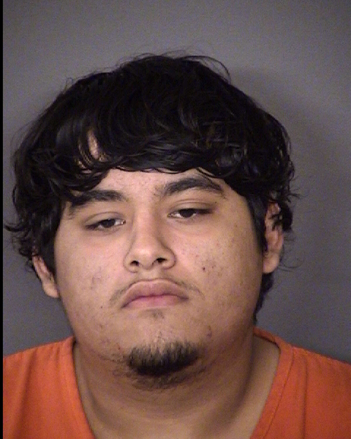 Roman Geraldo Perez, 19, is accused of forcing the driver of a Jeep SUV at gunpoint to visit several ATMs and withdraw cash on Sunday.