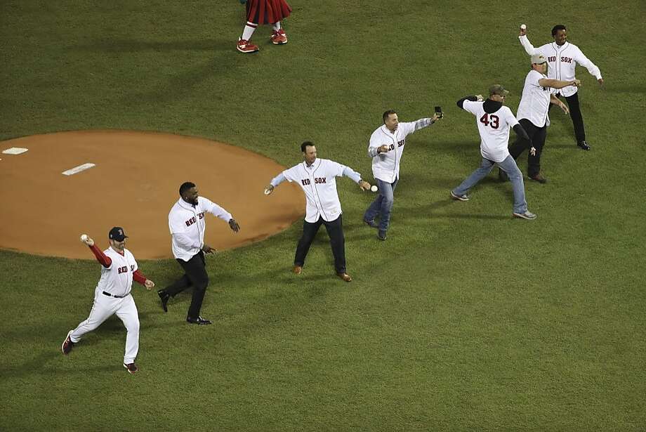 Members of the 2004 championship Boston Red Sox team deliver the ceremonial first pitch in Game 2 of the World Series against the Los Angeles Dodgers at Fenway Park in Boston, Oct. 24, 2018.  Photo: CHANG W. LEE, NYT