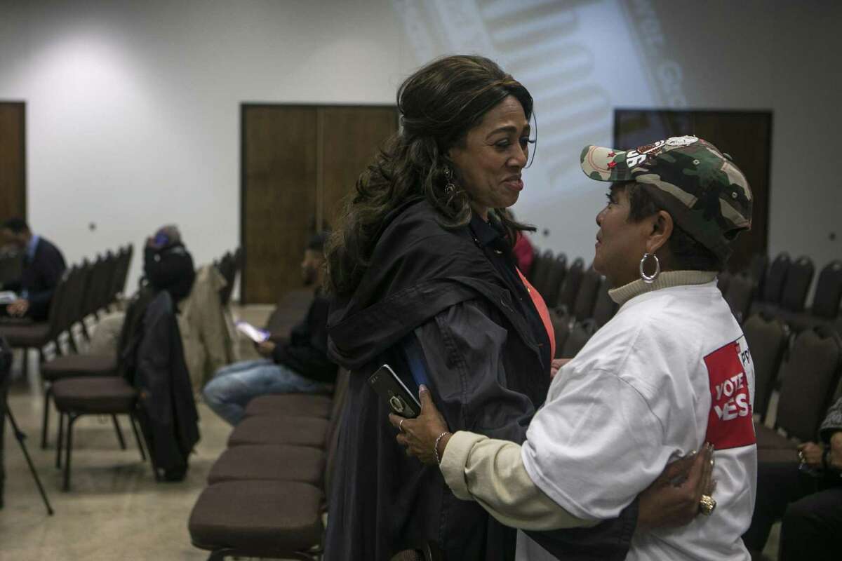 Cassandra Littlejohn and Grace Hernandez embrace before a town hall meeting held earlier this month at the Beasley Brown Community Center. Even though The two friends are on opposite sides of the Go Vote No and San Antonio First campaigns, but Littlejohn says, “We can agree to disagree.”