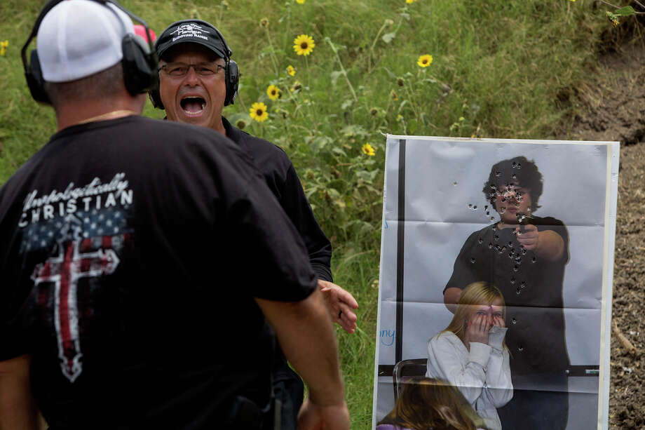 Range manager and head instructor Jaime Correa teaches a Principles of Active Shooter class to members of the church safety response team, including Shane Dahlberg, left, at LoneStar Handgun in Converse. / Lisa Krantz/San Antonio Express-News