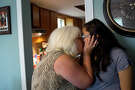 Michelle Shields kisses her daughter, Danielle Kelley, on August 6, 2018 at Michelle's home in Sutherland Springs. Danielle is the widow of the gunman who killed Shields' mother and 25 other parishioners at the church Danielle grew up in.