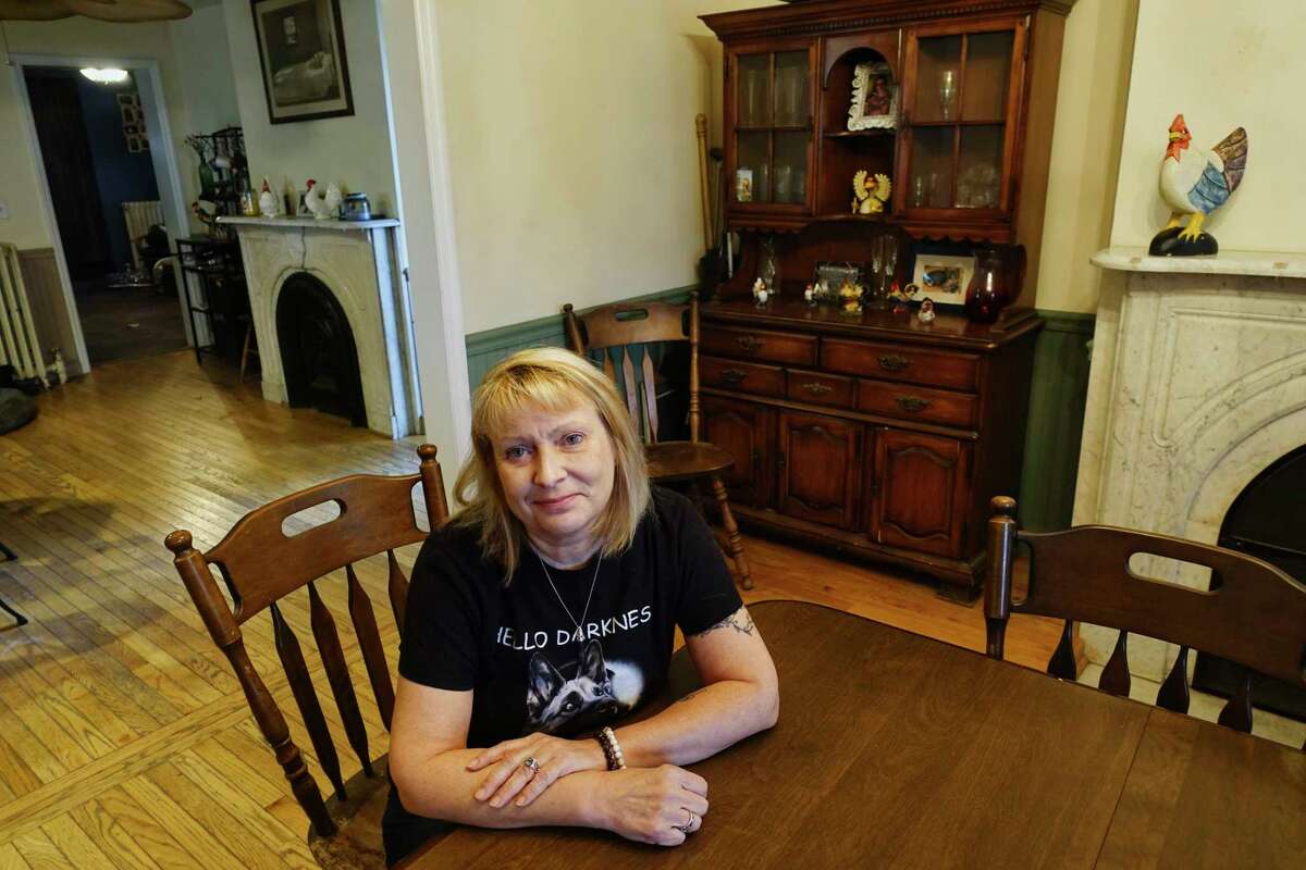 Mindy Connors poses for a photo in the dining room at her home on Wednesday, Oct. 24, 2018, in Watervliet, N.Y. Connors says that the dining room is the place where she and her family members sense the spirit of a grandmother the most in their home. The home,which Connors was born and raised in, was built in 1850. The grandmother, who's spirit they sense was the grandmother of a little boy, Jared, who died in the home of pneumonia. Connors and her family also see and sense the spirit of Jared in the home. (Paul Buckowski/Times Union)