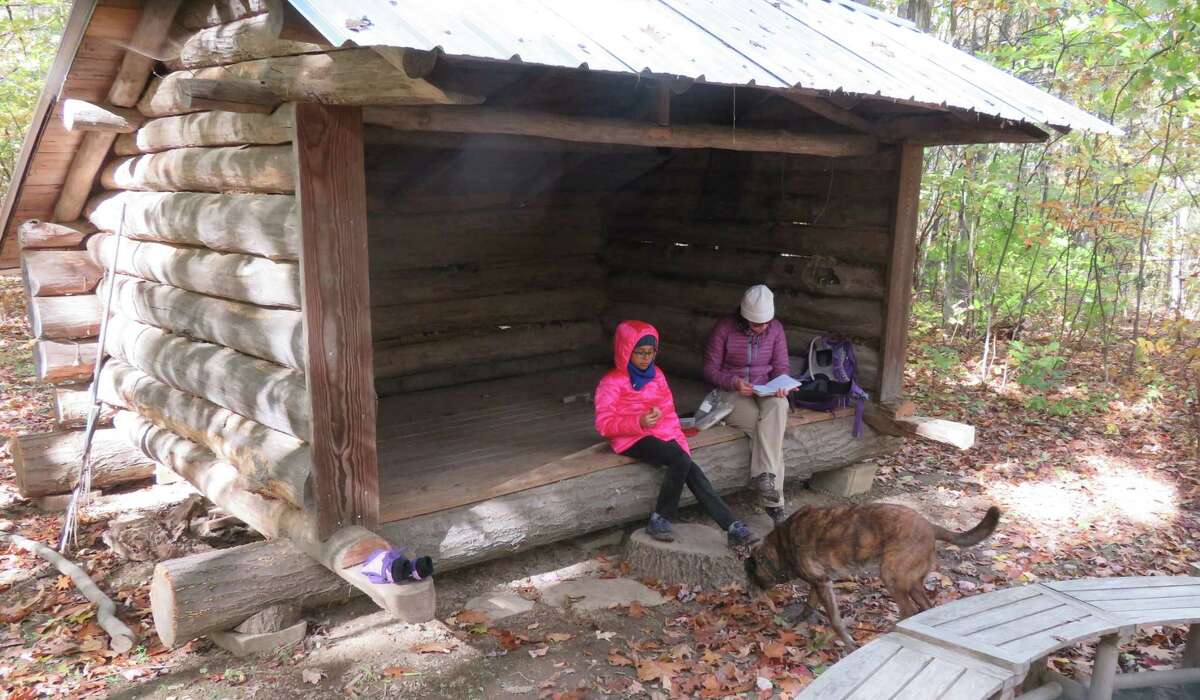Outdoor writer Gillian Scott and her foster daughter at the lean-to in the Sanders Preserve in Glenville. (Gillian Scott/Times Union)