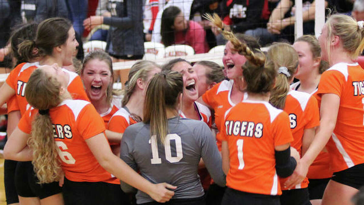 The Greenfield Tigers celebrate their first postseason championship since 2007 after beating Calhoun in three sets Thursday in the title match of the Calhoun Class 1A Sectional in Hardin.