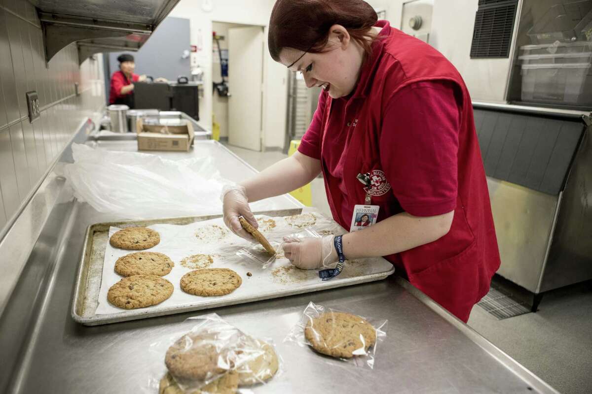 Olivia Shanks packages cookies in the cafeteria at Memorial Hermann Hospital Southwest on Tuesday, May 15, 2018, in Houston. Social Motion Skills is a nonprofit that offers a job-readiness internships to young adults with autism and similar special needs to transition into a work setting. It partners with the hospital to teach interns in the food service and cafeteria area. ( Brett Coomer / Houston Chronicle )