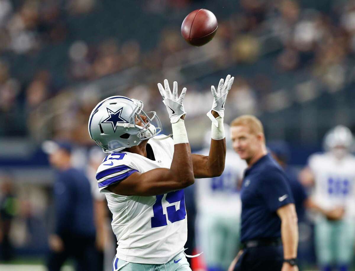 Dallas Cowboys wide receiver Brice Butler (19) catches a pass during team warmups as head coach Jason Garrett watches before a game against the Detroit Lions on Sunday, Sept. 30, 2018 at AT&T Stadium in Arlington, Texas.