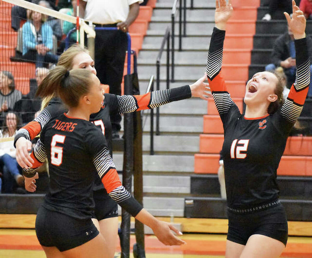 Edwardsville’s Morgan Tulacro, right, celebrates with Alexa Harris and Storm Suhre during the second game against Springfield on Thursday inside Lucco-Jackson Gymnasium.