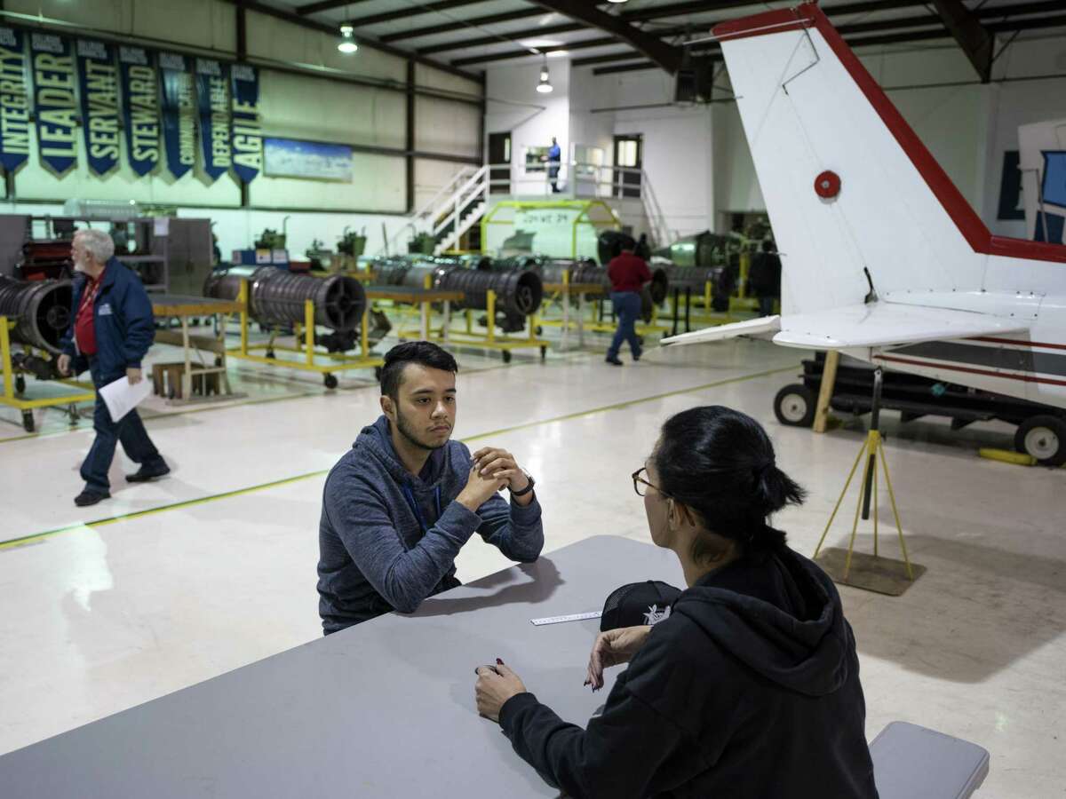 Current student at Hallmark University's College of Aeronautics, Luis Falcon, left, speaks with recent graduate Nicole Friello, at the University's lab and airplane hanger on Friday, October 19, 2018. Norm Hill Aviation donated 13 Rolls-Royce jet engines and an unnamed donor donated the Gulfstream III jet. Before the students can use these new acquisitions they must first receive approval from the Federal Aviation Administration (FAA) for their various projects.
