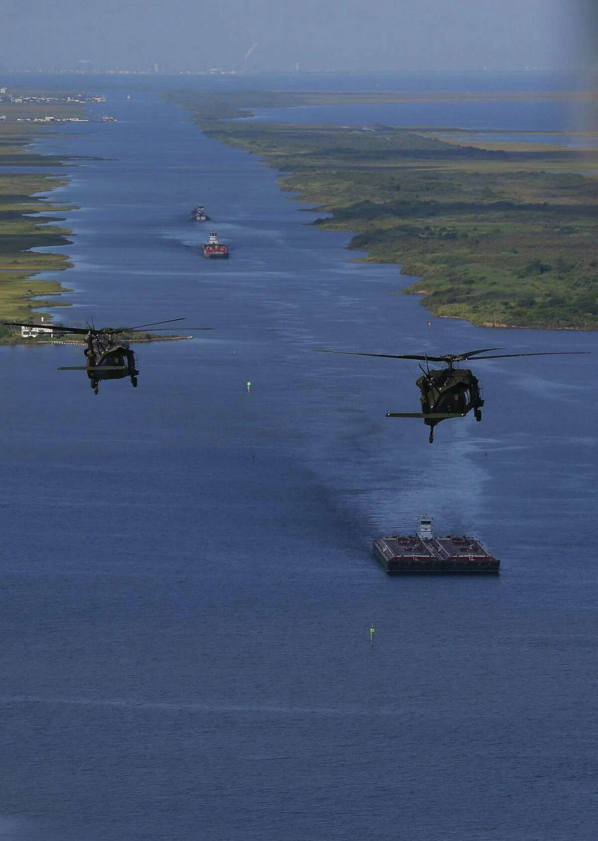 Army Black Hawk helicopters, carrying U.S. Army Corps of Engineers officials, flies over the Bolivar Peninsula Wednesday, September 7, 2016.
