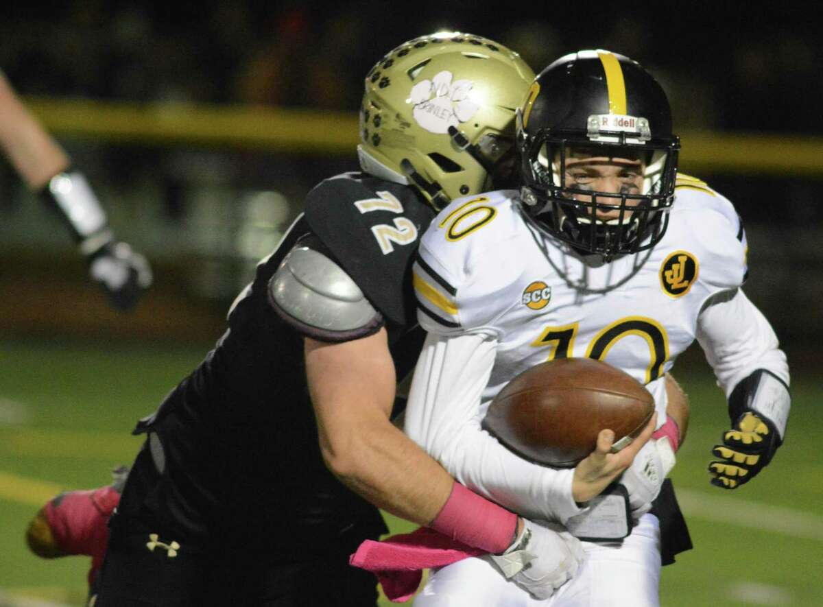 Law’s Zach Smith is sacked by Hand’s Ben Corniello during Friday’s game.