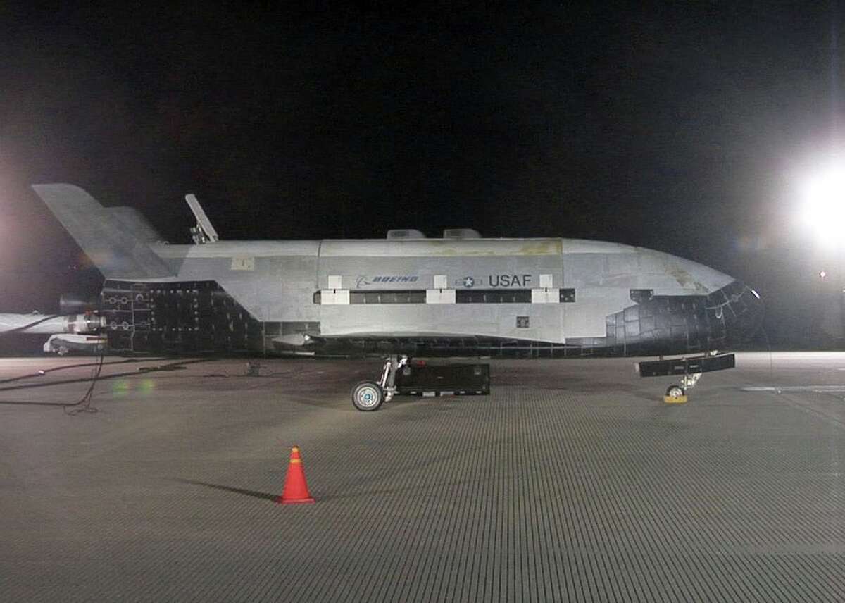 A shroud of darkness becomes the X-37B Orbital Test Vehicle. This photo shows the first X-37B, designated OTV-1, on the runway at Vandenberg Air Force Base in California on Dec. 3, 2010, just after it returned from its debut trip into space, which lasted 224 days. The second X-37B, OTV-2, touched down on Earth on June 16. It had lifted off on March 5, 2011 -- meaning it was orbit for 469 days, easily doubling the record of its older sibling.