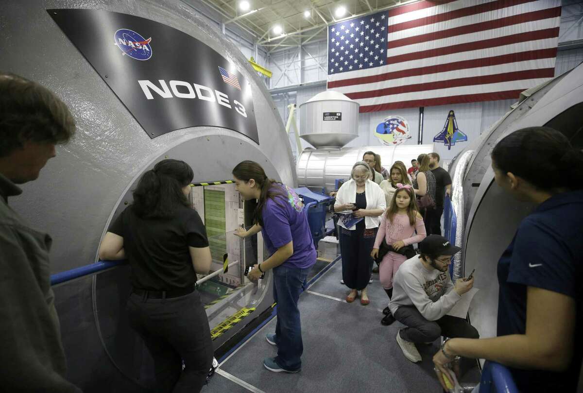 People tour mockup sections of the International Space Station at the Space Vehicle Mockup Facility in Building 9NW during the open house at NASA Johnson Space Center Saturday, Oct. 27, 2018, in Houston.