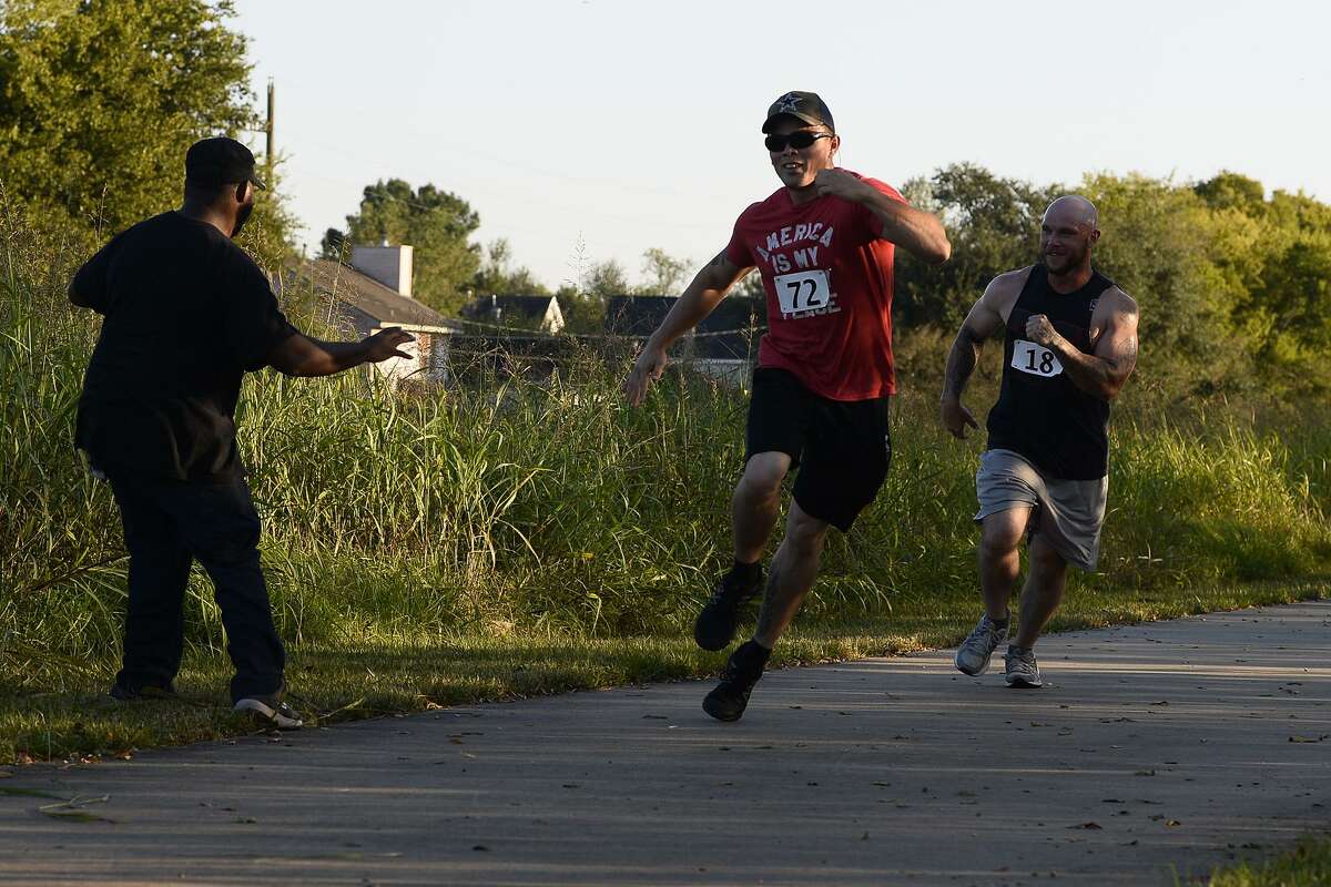 Elroy Rigsby-Leday scares runners while playing a zombie during the Zombie Run 5K at the Gulf Terrace Hike and Bike on Saturday afternoon. The run was a fundraiser for the Boomtown Film and Music Festival. Photo taken Saturday 10/27/18 Ryan Pelham/The Enterprise
