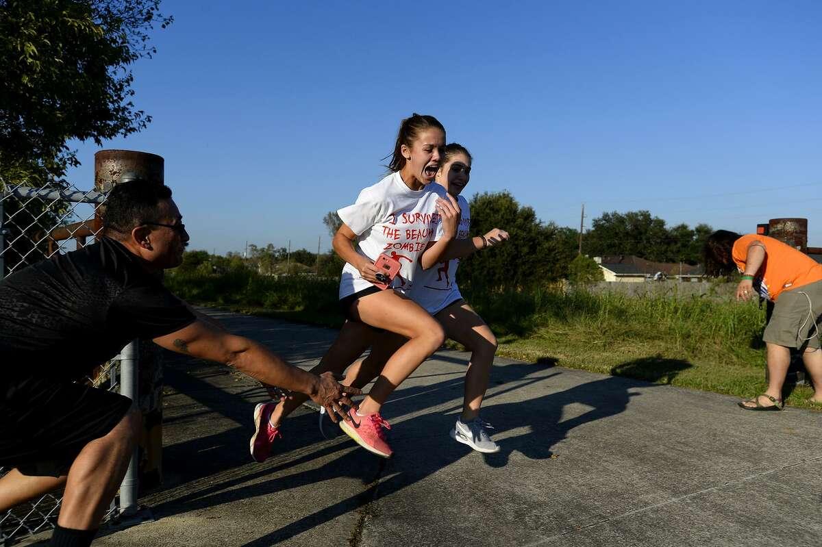 Runners try to avoid zombies during the Zombie Run 5K at the Gulf Terrace Hike and Bike on Saturday afternoon. The run was a fundraiser for the Boomtown Film and Music Festival. Photo taken Saturday 10/27/18 Ryan Pelham/The Enterprise