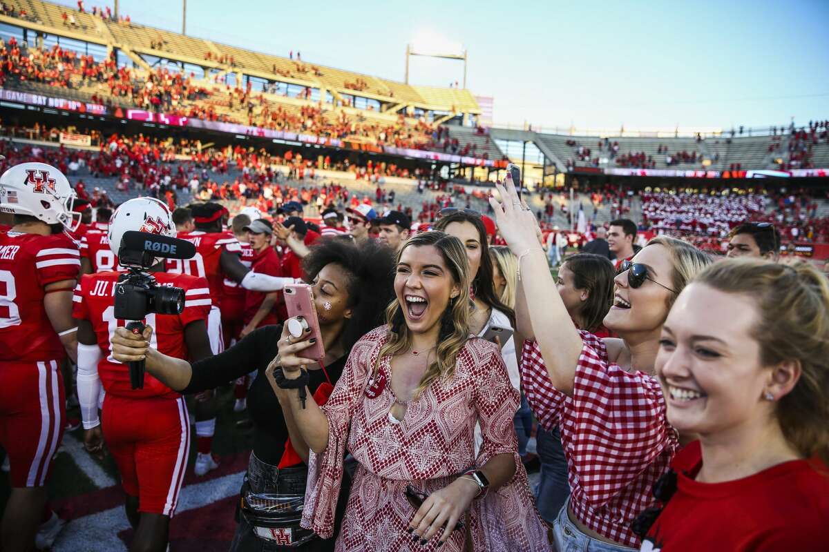 Fans who rushed the field celebrate after the Houston Cougars beat the South Florida Bulls 57-36 at TDECU Stadium Saturday, Oct. 27, 2018, in Houston.