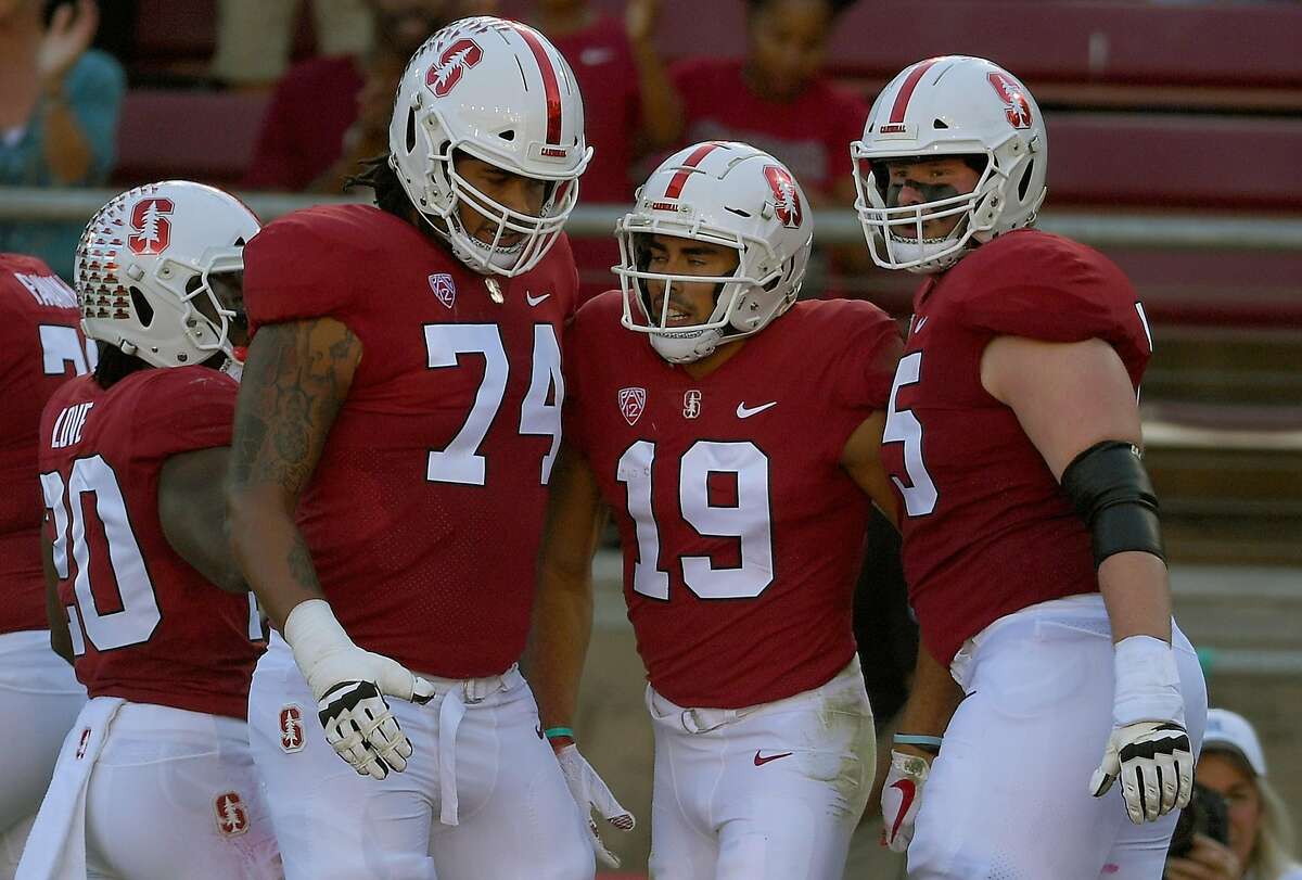PALO ALTO, CA - OCTOBER 27: JJ Arcega-Whiteside #19 of the Stanford Cardinal is congratulated by Bryce Love #20, Devery Hamilton #74 and Connor Wedington #5 after Arcega-Whiteside caught a touchdown pass against the Washington State Cougars during the first half of their NCAA football game at Stanford Stadium on October 27, 2018 in Palo Alto, California. (Photo by Thearon W. Henderson/Getty Images)
