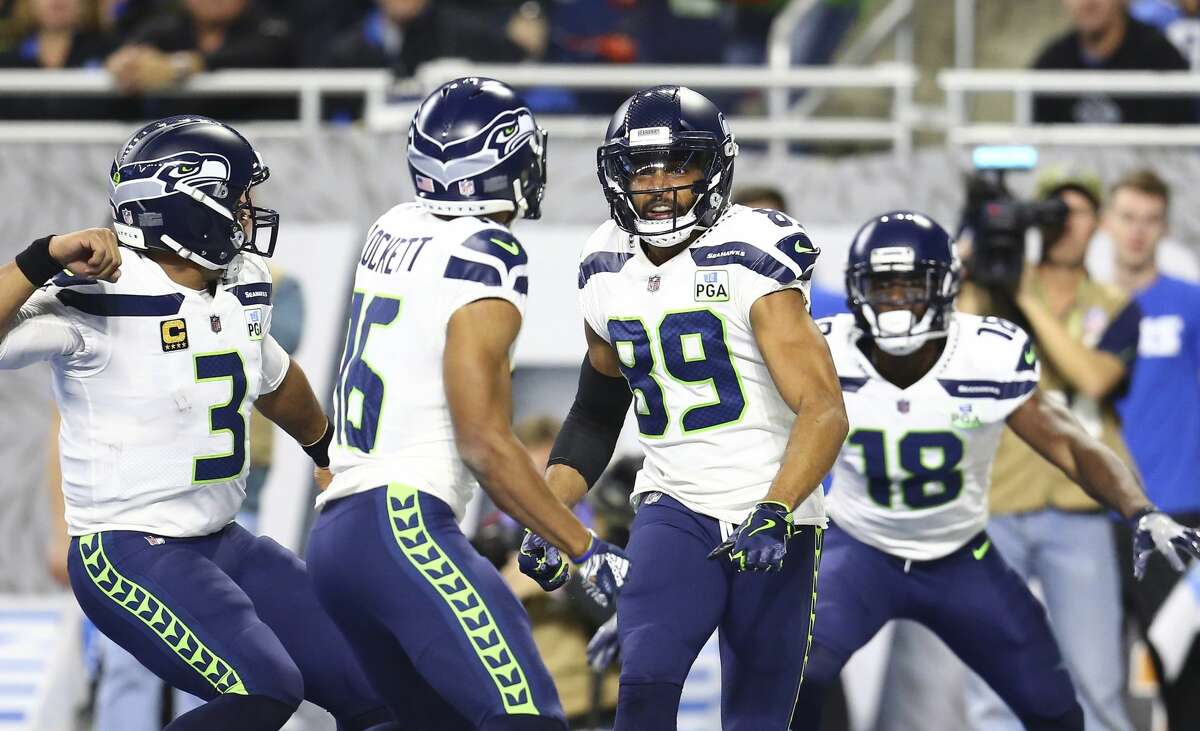 Seattle Seahawks wide receiver Doug Baldwin (89) runs to wide receiver Tyler Lockett (16) after Lockett's 24-yard touchdown reception during the first half of an NFL football game against the Detroit Lions, Sunday, Oct. 28, 2018, in Detroit. (AP Photo/Rey Del Rio)
