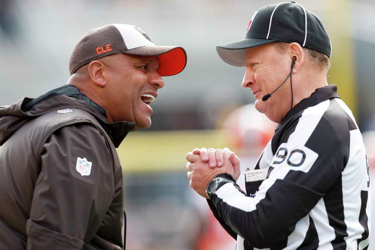 Cleveland Browns head coach Hue Jackson, left, talks with line judge Mike Spanier (90) along the sideline as his team plays against the Pittsburgh Steelers Sunday, Oct. 28, 2018, in Pittsburgh. The Steelers won 33-18.