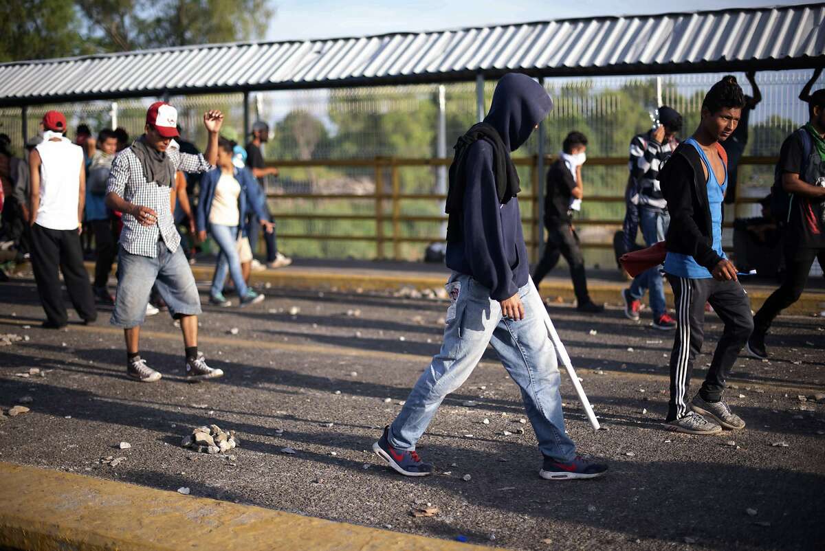 Central American migrants assemble on a border bridge connecting Guatemala and Mexico, in Tecun Uman, Monday, Oct. 29, 2018. The new group of migrants, who called themselves a second caravan, gathered on the bridge after forcing their way through a gate on Sunday, at the Guatemalan end and clashed with Mexican authorities. (AP Photo/Santiago Billy)