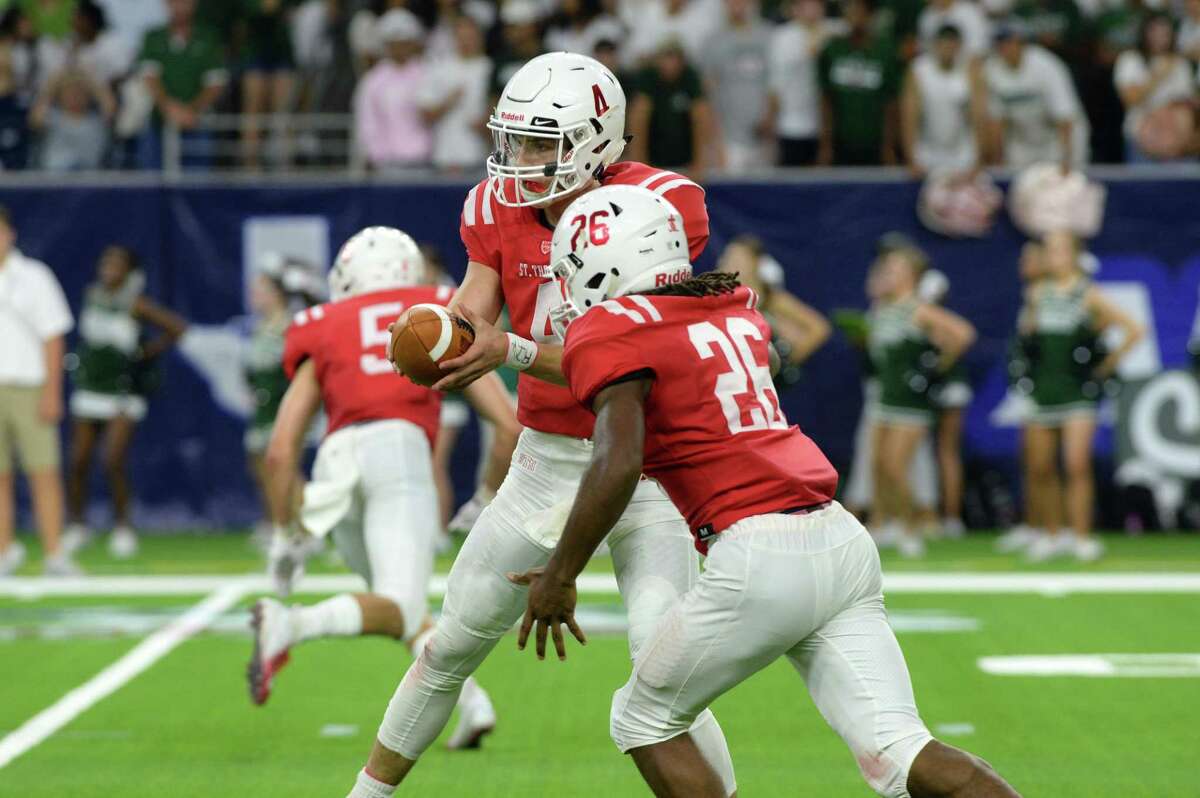 Quarterback Peyton Matocha (4) of St. Thomas hands off to Ian Wheeler (26) in the second quarter of a high school football game between the Strake Jesuit Crusaders and the St. Thomas Eagles on Friday, August 31, 2018 at NRG Stadium, Houston, TX.