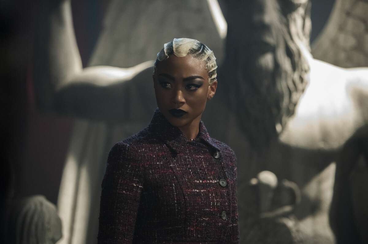 A still from Netflix's "The Chilling Adventures of Sabrina" depicting the Baphomet figure in the background behind Prudence (Tati Gabrielle).
