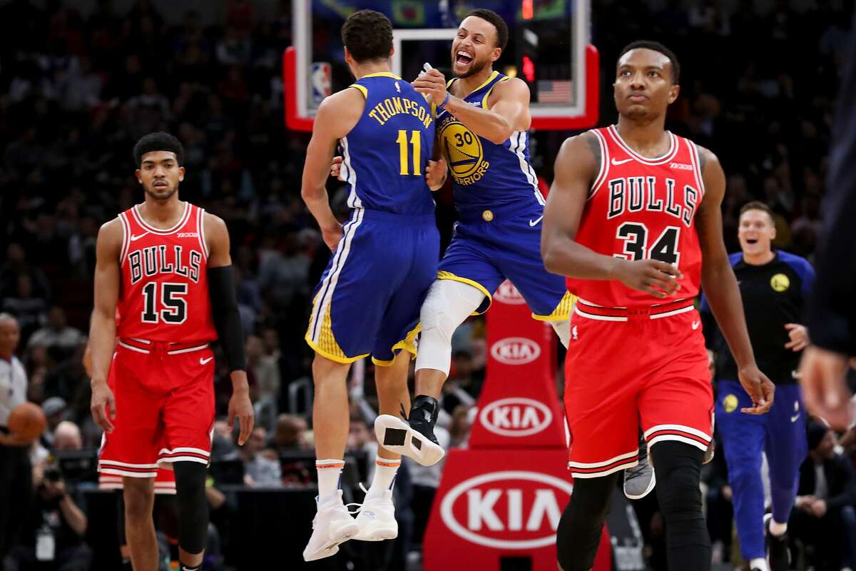 Golden State Warriors guard Klay Thompson (11) and Golden State Warriors guard Stephen Curry (30) celebrate after the Bulls call a timeout during the first half at the United Center Monday Oct. 29, 2018, in Chicago. (Armando L. Sanchez/Chicago Tribune/TNS)