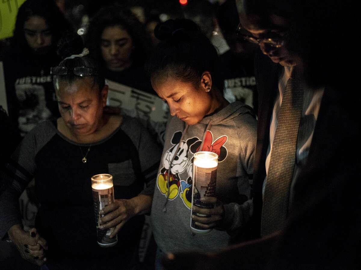 Patricia Slack, mother of Charles Roundtree Jr., center, and Arlene Castillo, grandmother to Roundtree, left, pray together during a protest outside of the San Antonio Police's Public Safety Headquarters on Friday, October 26, 2018. The protest is being held to call attention to the death of 18-year-old Charles "Chop Chop" Roundtree Jr., who was fatally shot by a bullet meant for another person in a West Side home during a confrontation with the San Antonio police last week.