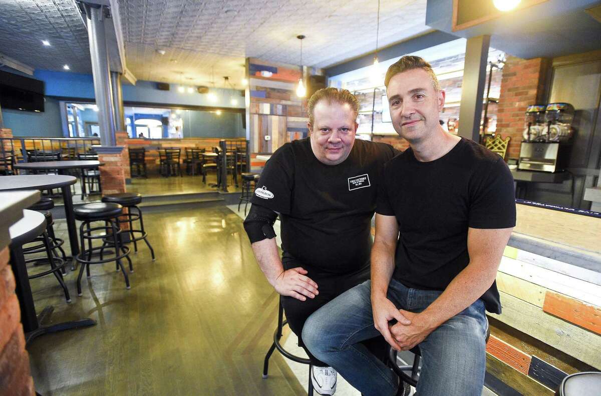 From left, Louie Colantonio and Donny Guarino, two of the three managing partners of Factory Bar & Grill, are photographed in the restaurant, on May 22, 2018, at 261 Main St., in Stamford, Conn.