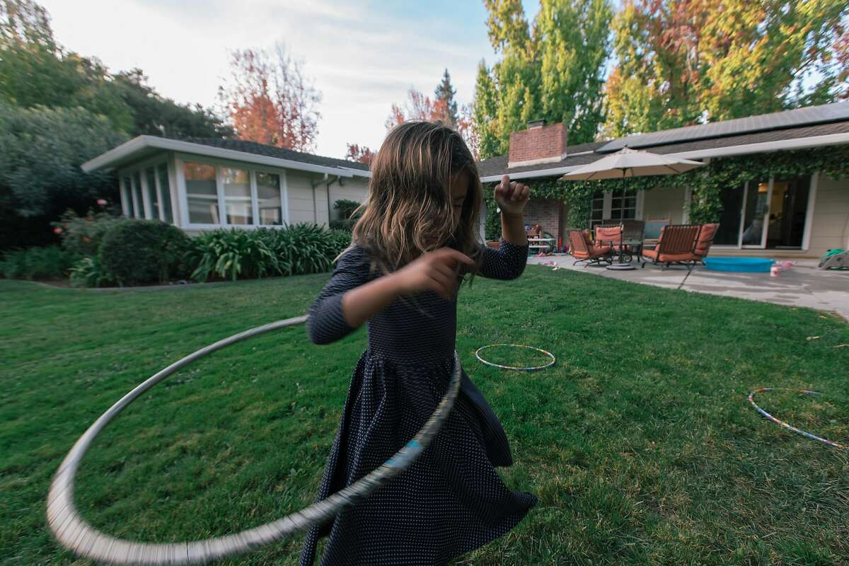 One of Kristin Stetcher's daughters, who she said have no screen time "budget," plays in their backyard in Menlo Park, Calif., Oct. 26, 2018. A wariness that has been slowly brewing is turning into a regionwide consensus: The benefits of screens as a learning tool are overblown. (Peter Prato/The New York Times)