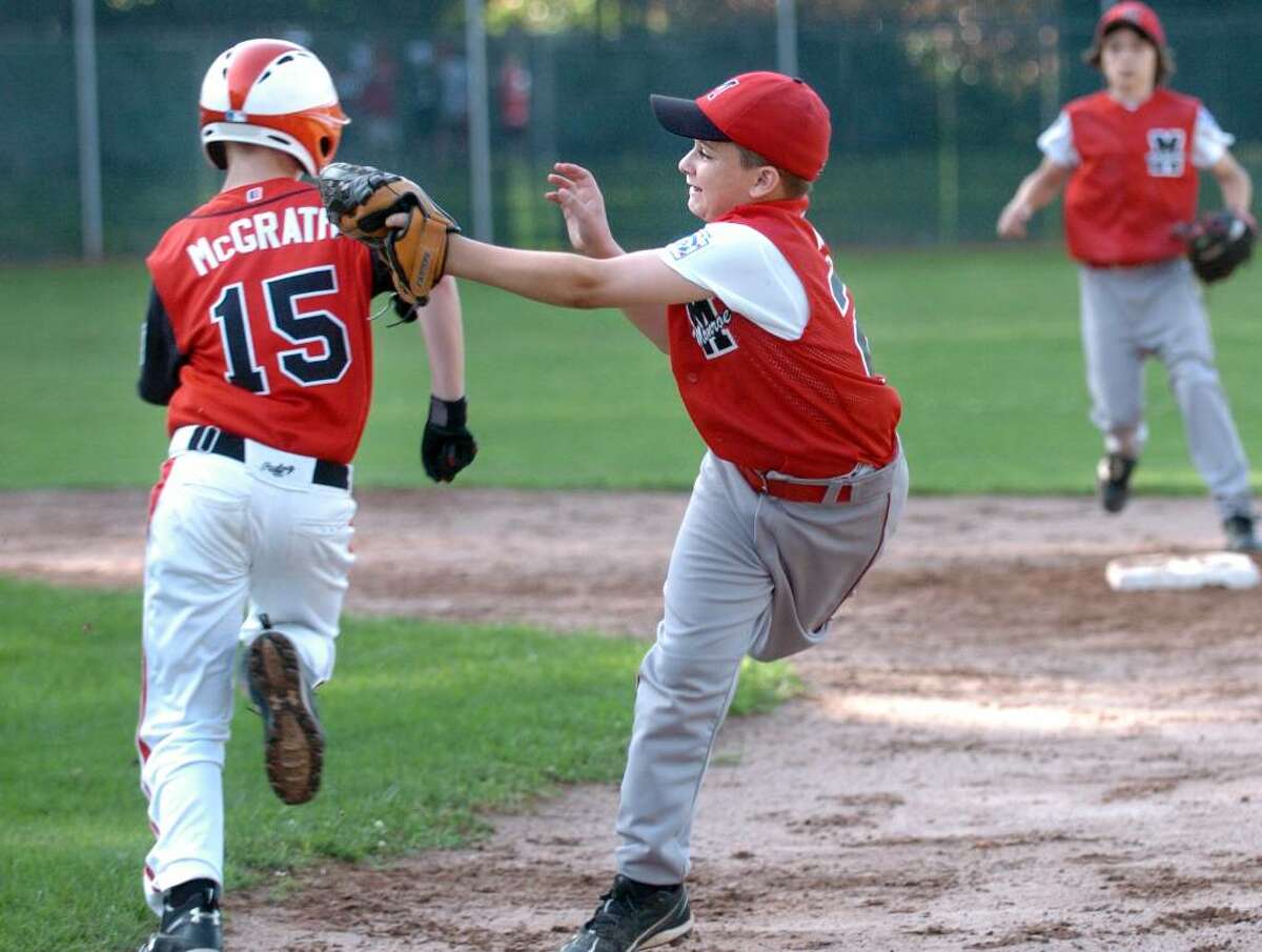 Fairfield American's Billy McGrath avoids a tag by Monroe's Nick Maini on his way to second base during the District 2 little league tournament game Thursday July 15, 2010 at Blackham School field in Bridgeport.