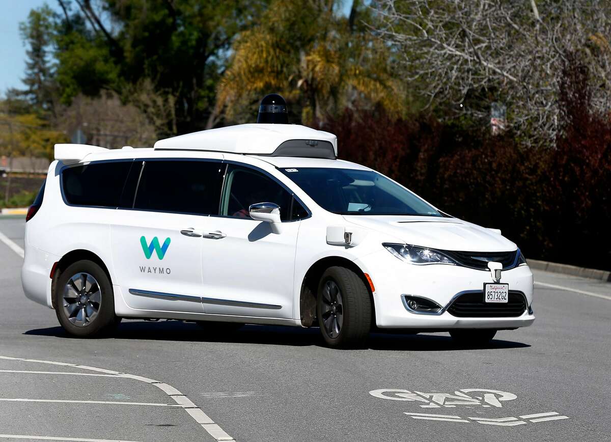 A Waymo self-driving car drives on a residential street in Mountain View, Calif. on Wednesday, March 28, 2018.