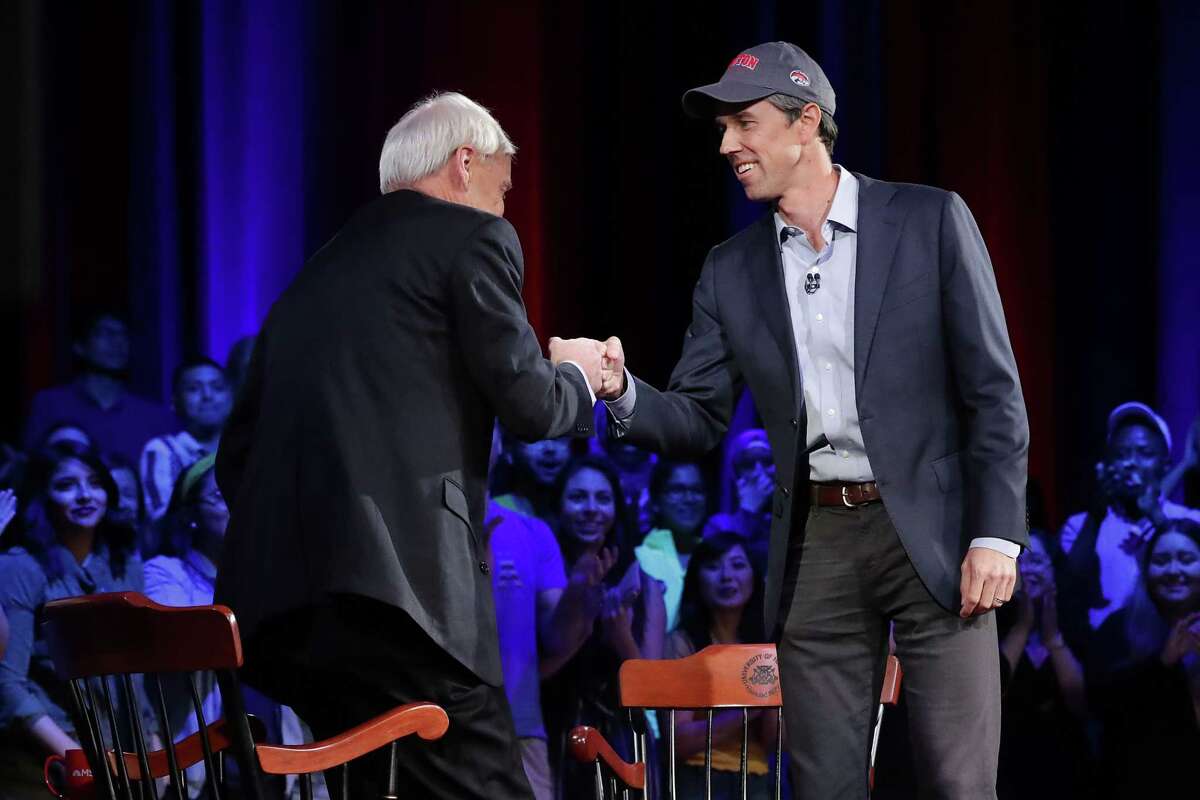 U.S. Senate candidate Rep. Beto O'Rourke (D-TX) (R) fist bumps MSNBC host Chris Matthews during a town hall meeting at the Cullen Performance Center at the University of Houston October 30, 2018 in Houston, Texas. 
