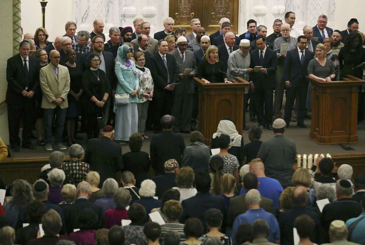 Religious and civic leaders gather on stage to sing, This Land is Your Land, as Temple Beth-El hosts a memorial in the wake of last weekend's shooting deaths in a Pittsburgh synagogue on Tuesday, Oct. 30, 2018. As the first funerals took place for the 11 Jewish congregants who were gunned down by a deranged anti-semite at the Tree of Life synagogue in Pittsburgh, the San Antonio Jewish community gathered at Temple Beth-El and opened their place of worship to the public to mourn the victims. (Kin Man Hui/San Antonio Express-News)