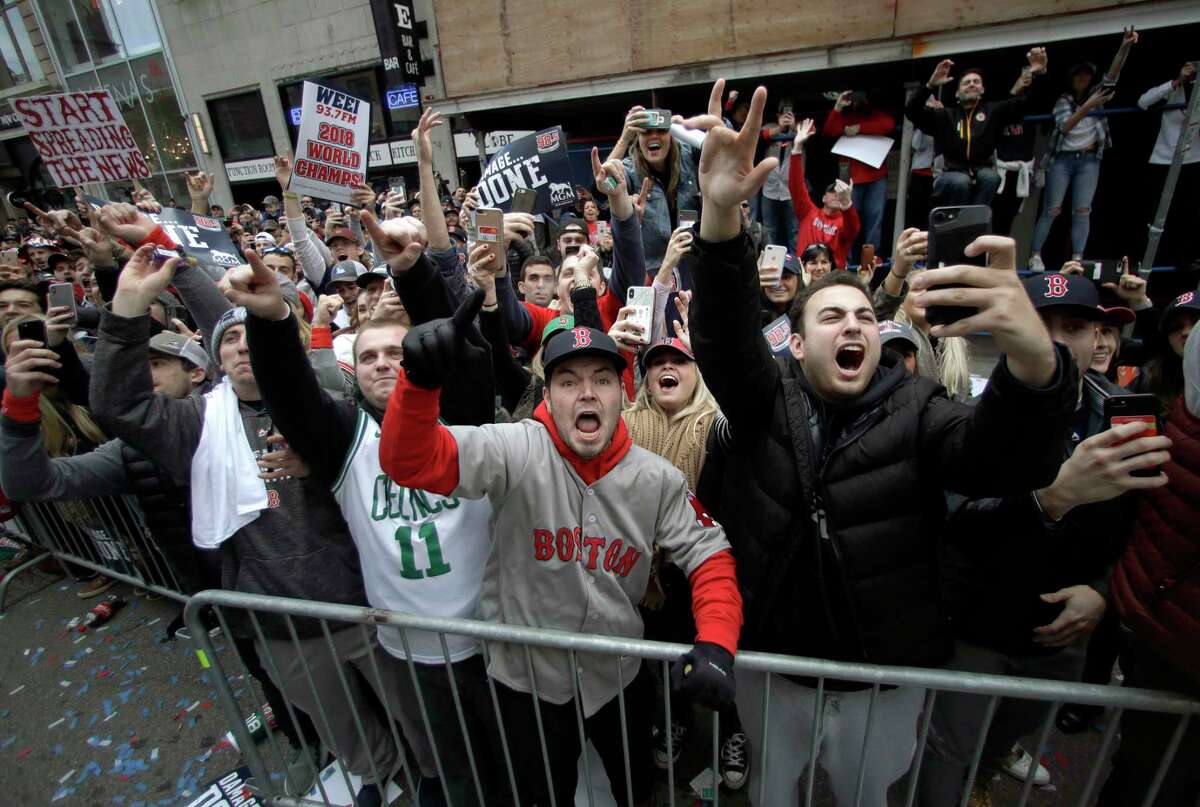 Boston Red Sox fans cheer during a parade to celebrate the team's World Series championship over the Los Angeles Dodgers, Wednesday, Oct. 31, 2018, in Boston.