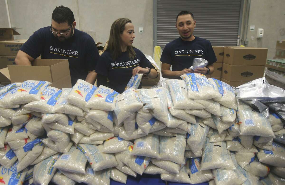 Volunteers from USAA pack boxes of food for seniors Friday November 3, 2017 at the San Antonio Food Bank. Food banks across the country say they welcome the upcoming influx of food the USDA is buying to make up for export markets lost to trade war tariffs but aren’t prepared logistically to handle it.