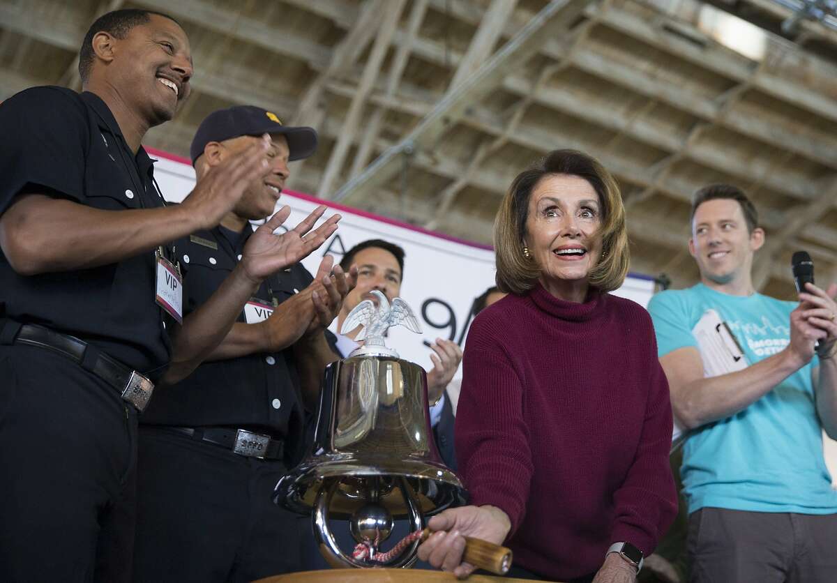House Minority Leader Nancy Pelosi rings the bell to officially kick off a meal packing event held by the 9/11 Day organization honoring the national Day of Service at Pier 35 in San Francisco, Calif. Tuesday, Sept. 11, 2018.
