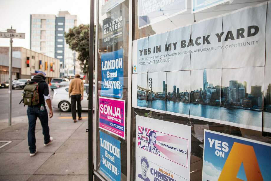 Multiple campaign posters are seen in the windows of the YIMBY Action headquarters in San Francisco, Calif. Tuesday, Oct. 23, 2018. Photo: Jessica Christian / The Chronicle