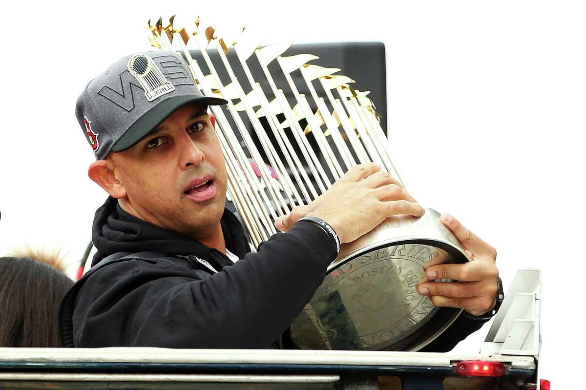 BOSTON, MA - OCTOBER 31: Boston Red Sox Manager Alex Cora holds the World Series trophy during the 2018 World Series victory parade on October 31, 2018 in Boston, Massachusetts.