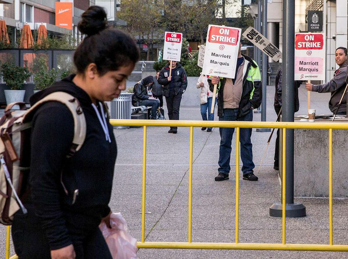 Marriott workers on strike picket as workers from Salinas, Calif. are dropped off by a shuttle bus to work at the Marriott Marquis in San Francisco, Calif. Tuesday, Oct. 30, 2018.