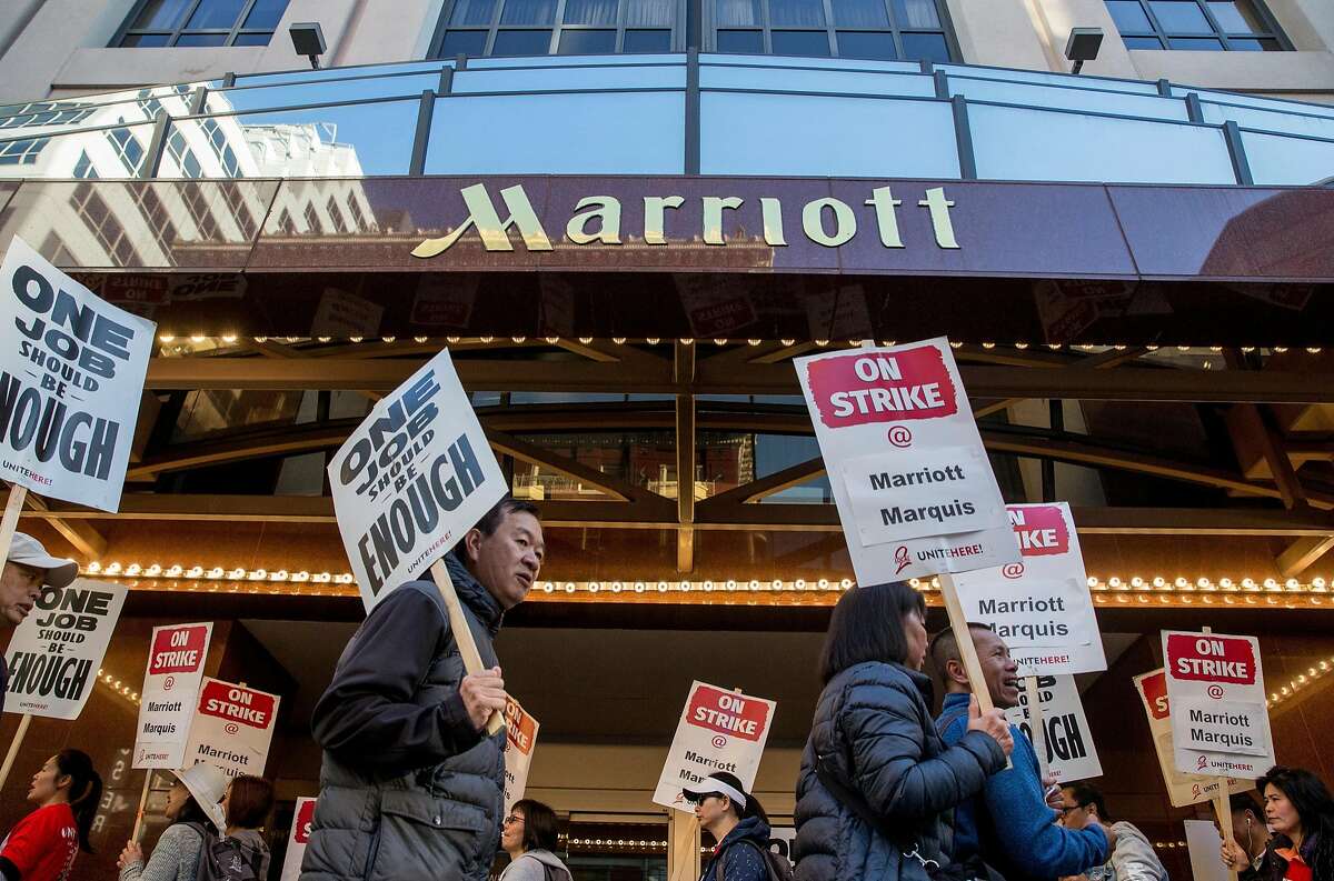 Marriott-affiliated hotel and hospitality workers strike outside of the Marriott Marquis hotel Saturday, Oct. 20, 2018 in San Francisco, Calif. before taking the streets in a massive march.