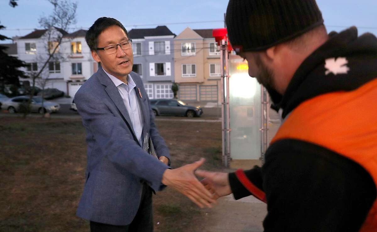 District 4 candidate Gordon Mar (left) campaigns on Judah St. at Sunset Blvd. shaking hands with Eric Dunn (right) on Wednesday morning, Oct. 31, 2018, in San Francisco, Calif.