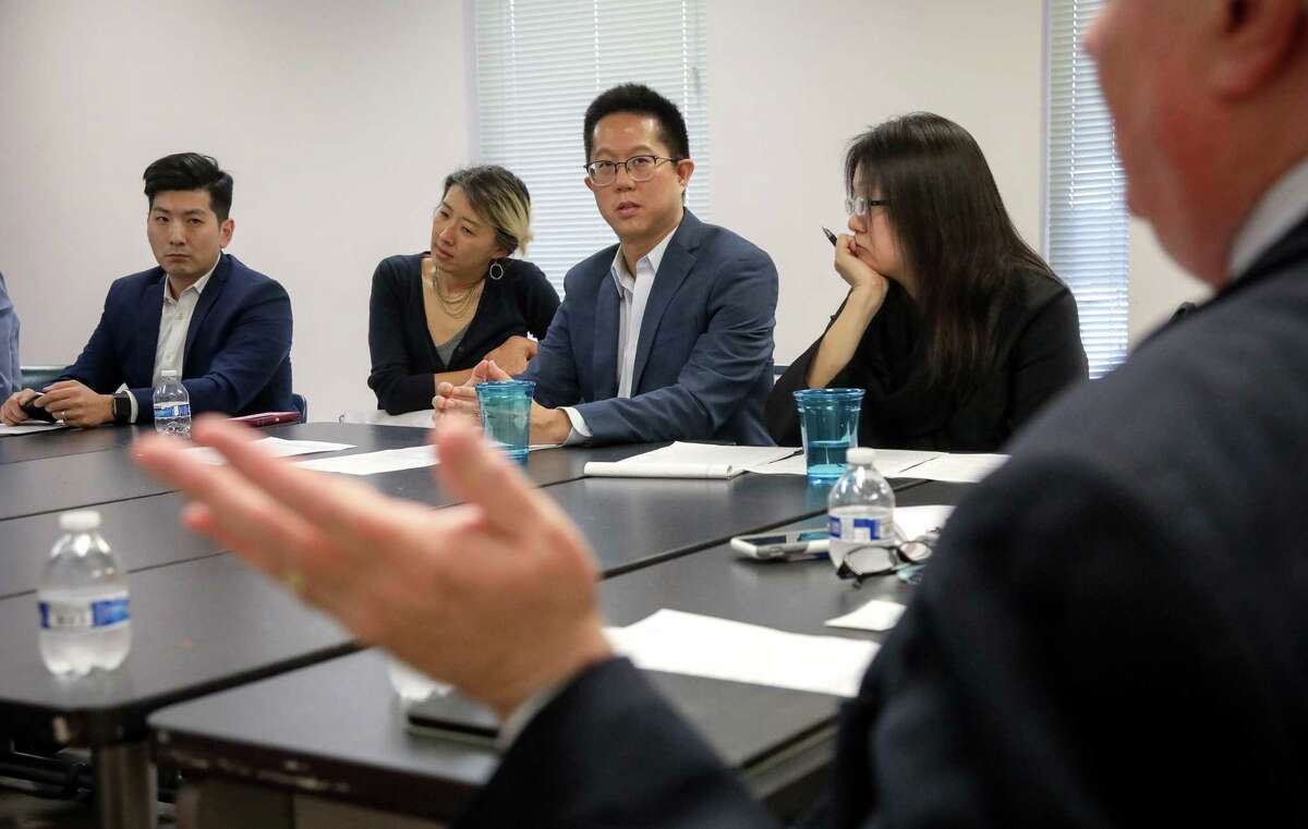 Sang Shin, from left, an attorney, Dona Murphy, Andrew Chongseh Kim, an attorney and Debbie Chen, also an attorney, listen as Harris County Clerk Stan Stanart explains the county's position on Korean-language interpreters during a meeting at the Korean Community Center, Wednesday, Oct. 31, 2018, in Houston. The county clerk's office met with Korean-American voters after several translators had been barred from the Trini Mendenhall Community Center voting location on Sunday.