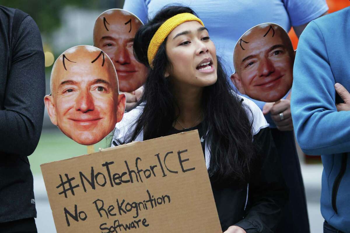 Elizabeth Pring participates in a protest at Amazon against the company's actions providing their facial recognition software, "Rekognition," to the Immigration and Customs Enforcement Agency (ICE), Wednesday, Oct. 31, 2018. Demonstrators held Jeff Bezos masks and shouted "No tech for ICE!" The event was organized by NWDC Resistance and Mijente.