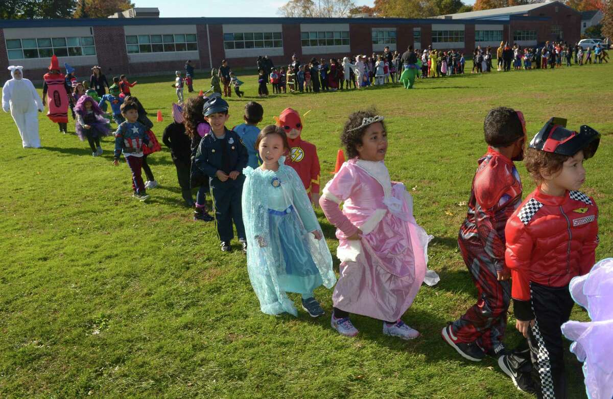Students walk the field as the Brookside Elementary School annual schoolwide Halloween Parade Wednesday, October 31, 2018, at the school in Norwalk, Conn.