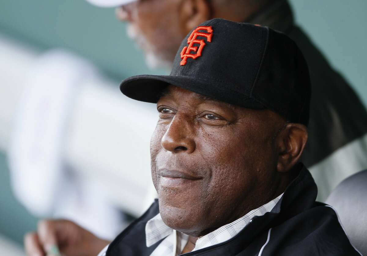 FILE - In this March 8, 2010, file photo, San Francisco Giants Hall of Famer Willie McCovey watches batting practice from the dugout before the Giants' spring training baseball game against the Los Angeles Dodgers in Scottsdale, Ariz. McCovey, the sweet-swinging Hall of Famer nicknamed "Stretch" for his 6-foot-4 height and those long arms, has died. He was 80. The San Francisco Giants announced his death, saying the fearsome hitter passed “peacefully” Wednesday afternoon, Oct. 31, 2018, “after losing his battle with ongoing health issues.” (AP Photo/Eric Risberg, File)