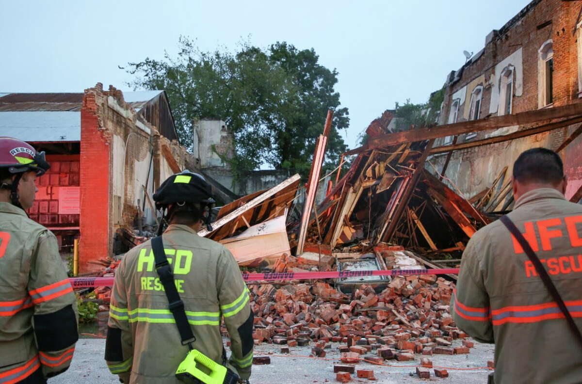 Houston Fire Department firefighters at the scene where a building collapsed on Congress Avenue near Bastrop Street Thursday, Nov. 1, 2018, in Houston.