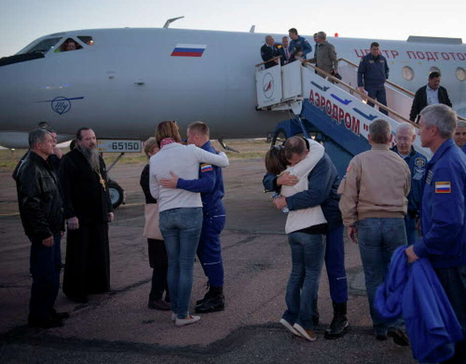 Flight Engineer Alexey Ovchinin of Roscosmos, left, and Flight Engineer Nick Hague of NASA, right,  embrace their families after landing at the Krayniy Airport, Monday, Oct. 8, 2018 in Baikonur, Kazakhstan. The two were on their way to the International Space Station.
>>See how the space station has changed over the years... Photo: Bill Ingalls, Associated Press / (NASA/Bill Ingalls) For copyright and restrictions refer to - http://www.nasa.gov/multimedia/guidelines/index.html