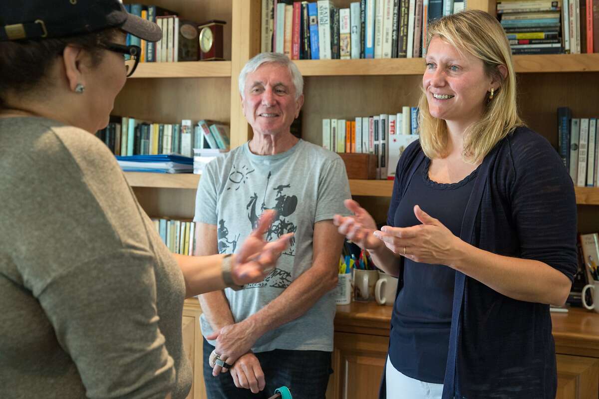 Buffy Wicks, (right) a candidate for the 15th State Assembly district, talks with a supporter Jacqueline Noguera and Sam Burd during a house party hosted by Carmen Murray, leader in the local Organizing For Action group. On Sunday, October 7, 2018 in Oakland Calif.