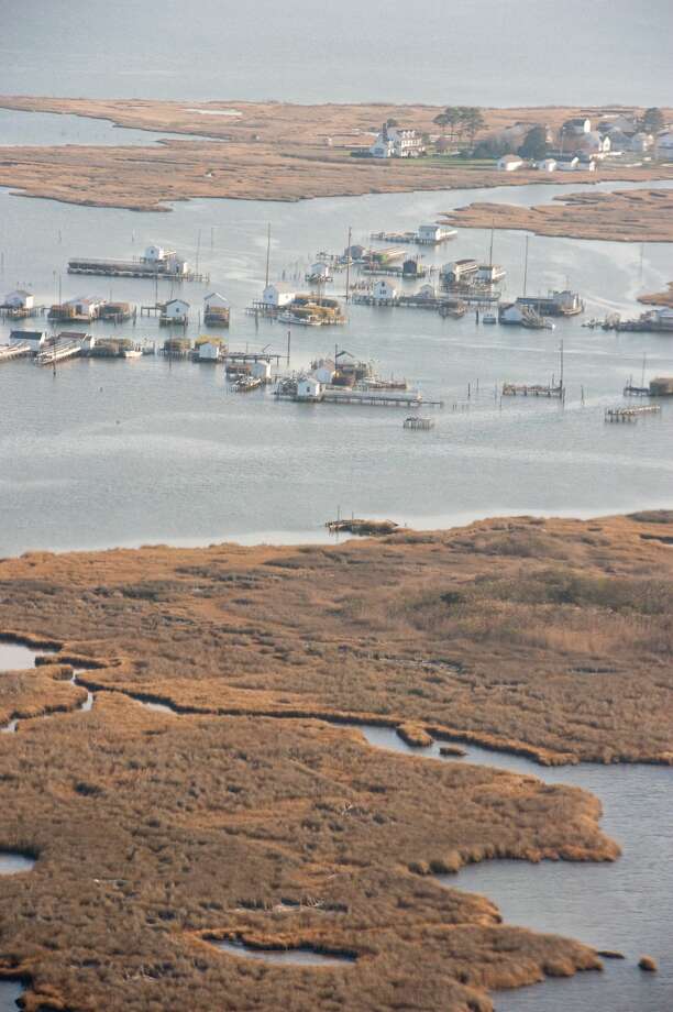 This island too is in trouble: As the New Yorker wrote in June in its story Tangier, the Sinking Island in the Chesapeake: "A combination of storm-driven erosion and sea-level rise, which are both increasing as climate change advances, may soon swallow the island entirely."
The supporting research for the New Yorker story adds, "Climate change and associated sea level rise (SLR) are already impacting low-lying coastal areas, including islands, throughout the world. Many of these areas are inhabited, many will need to be abandoned in coming decades as SLR continues.
"We examine the evolution (1850-2013) of the last inhabited offshore island in Virginia waters of Chesapeake Bay USA, the Tangier Islands. ... Since 1850, 66.75% of the islands landmass has been lost. Under the mid-range SLR scenario, much of the remaining landmass is expected to be lost in the next 50 years and the Town will likely need to be abandoned." Photo: The Washington Post/Getty Images