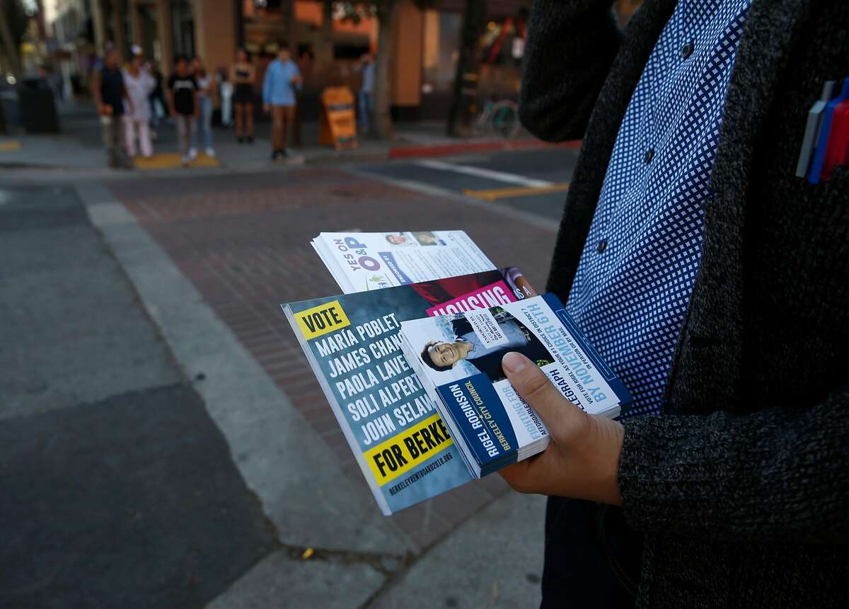 Rigel Robinson, a candidate running for the Berkeley City Council District 7 seat, carries voter information while walking on Telegraph Avenue in Berkeley, Calif. on Saturday, Oct. 27, 2018.